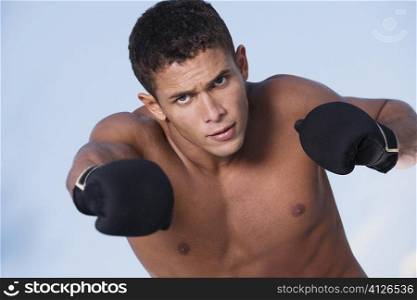 Portrait of a young man punching