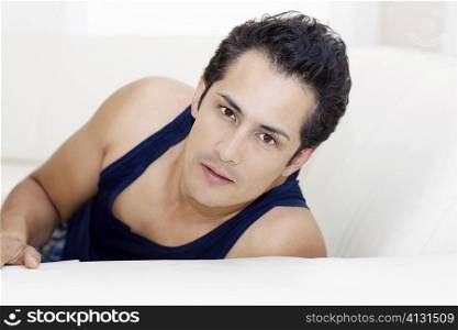 Portrait of a young man reclining on a couch