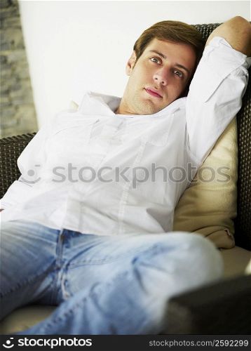 Portrait of a young man relaxing on a couch