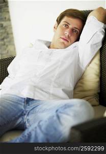Portrait of a young man relaxing on a couch