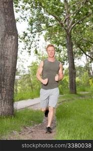 Portrait of a young man running in a park