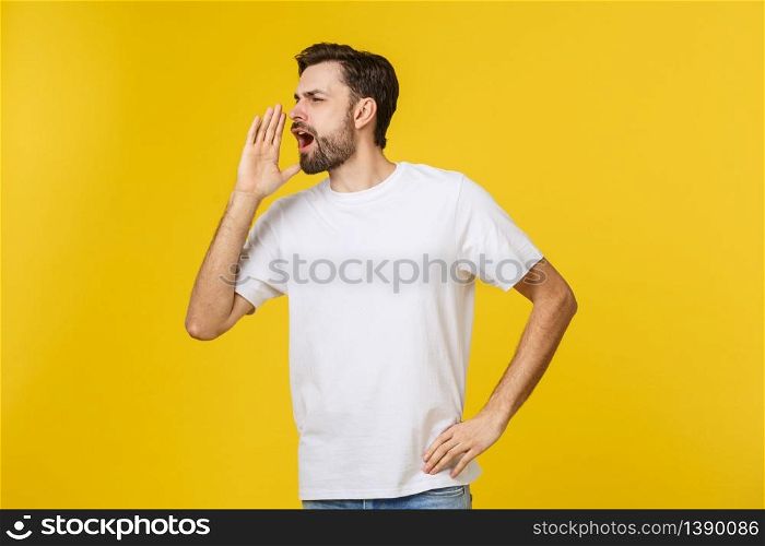 Portrait of a young man shouting loud with hands on the mouth. Portrait of a young man shouting loud with hands on the mouth.