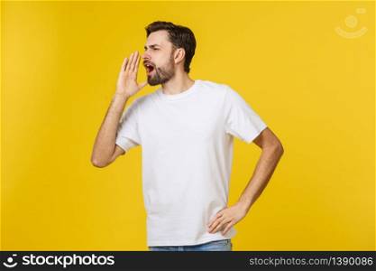 Portrait of a young man shouting loud with hands on the mouth. Portrait of a young man shouting loud with hands on the mouth.