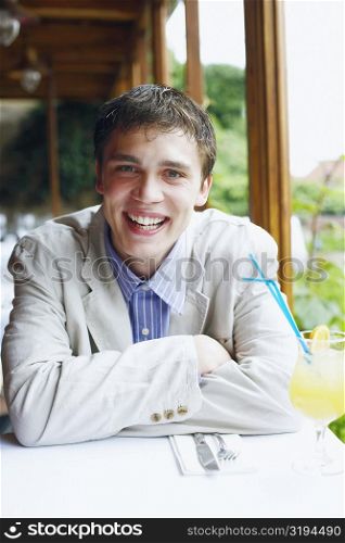 Portrait of a young man sitting in a restaurant