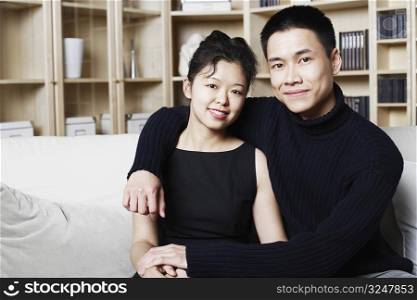 Portrait of a young man sitting with a young woman smiling