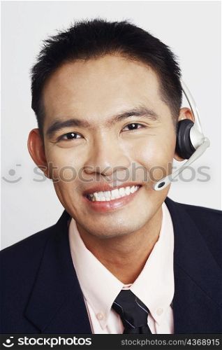 Portrait of a young man smiling and wearing a headset
