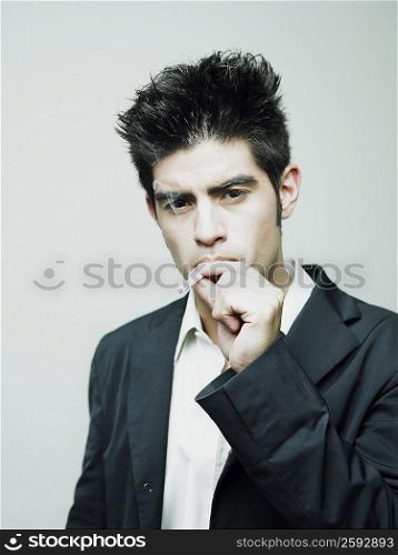 Portrait of a young man smoking a cigarette