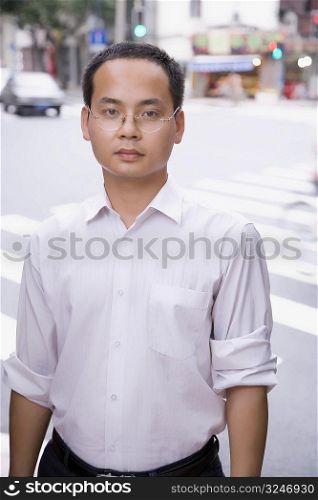 Portrait of a young man standing on a road