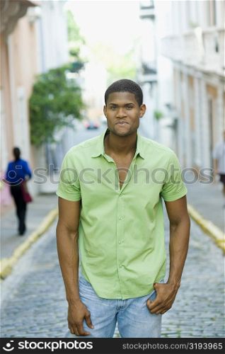 Portrait of a young man standing on the street