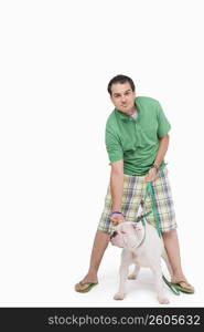 Portrait of a young man standing with a dog