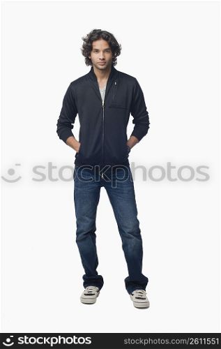 Portrait of a young man standing with his hands in his pockets