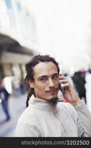 Portrait of a young man talking on a mobile phone