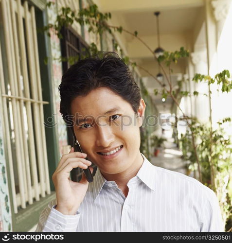 Portrait of a young man talking on a mobile phone