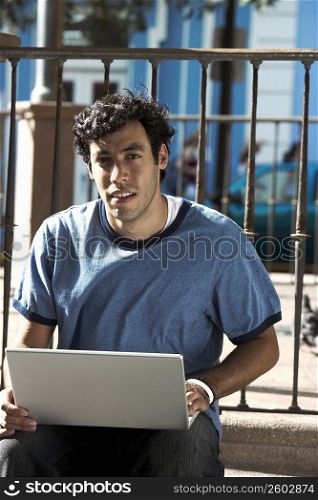 Portrait of a young man using a laptop
