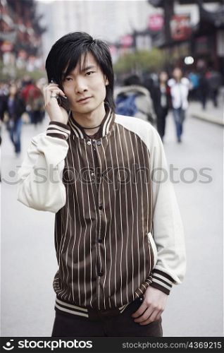 Portrait of a young man using a mobile phone