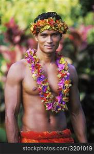 Portrait of a young man wearing a garland, Hawaii, USA