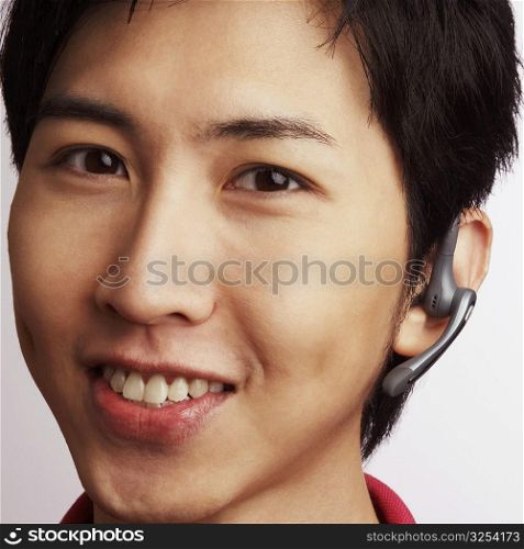 Portrait of a young man wearing a hands-free device