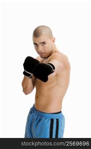 Portrait of a young man wearing boxing gloves