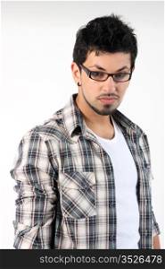Portrait of a young man wearing glasses on the drey background