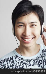 Portrait of a young man wearing headphones and listening to music