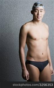 Portrait of a young man wearing racing briefs and smiling