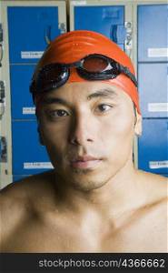 Portrait of a young man wearing swimming cap
