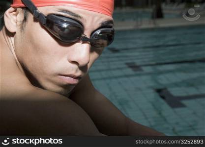 Portrait of a young man wearing swimming goggles