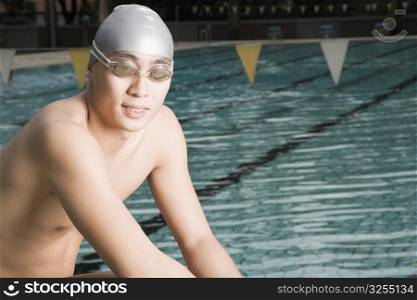 Portrait of a young man wearing swimming goggles