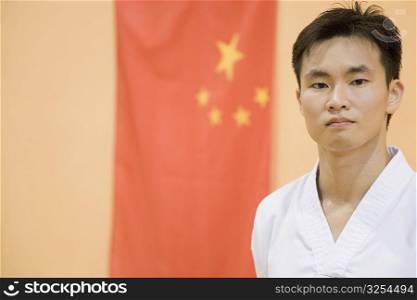 Portrait of a young man with a Chinese flag in the background