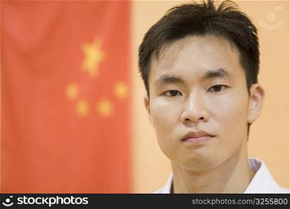 Portrait of a young man with a Chinese flag in the background