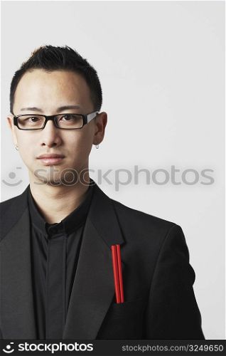 Portrait of a young man with a pair of chopsticks in his pocket