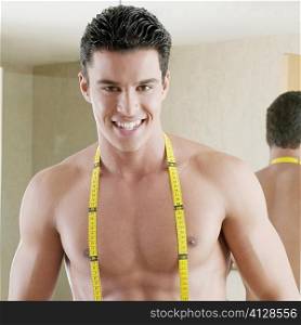 Portrait of a young man with a tape measure around his neck