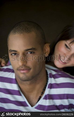 Portrait of a young man with a young woman smiling