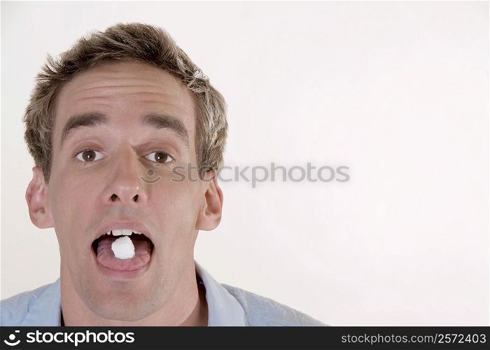 Portrait of a young man with candy in his mouth