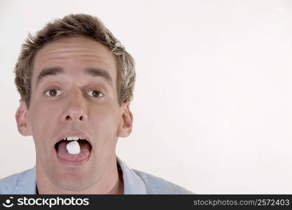 Portrait of a young man with candy in his mouth