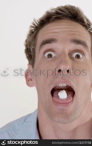 Portrait of a young man with candy in his mouth