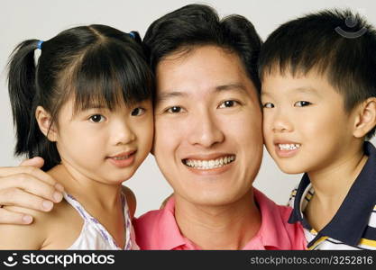 Portrait of a young man with his son and daughter