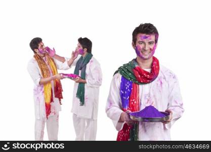 Portrait of a young man with holi colour