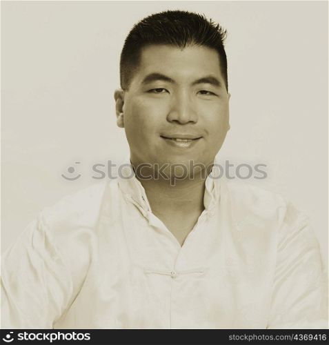 Portrait of a young man wrapping a gift and smiling