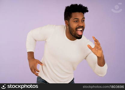 Portrait of a young motivated man running away against isolated background. Success concept.