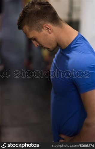 Portrait of a young muscular fitness trainer at the gym