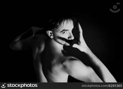 portrait of a young naked man dancing close up