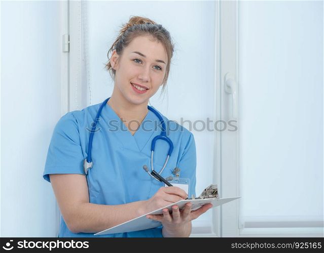 portrait of a young nurse in blue uniform