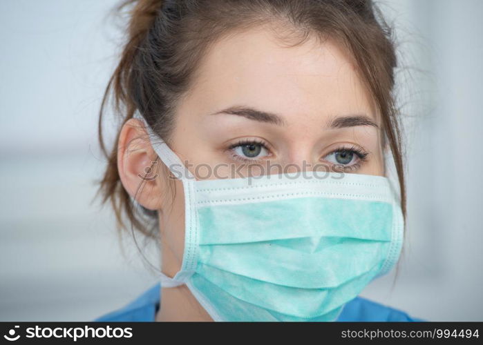 portrait of a young nurse with a mask