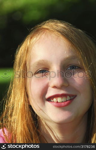 Portrait of a young pretty girl outside in summertime