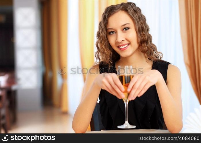 Portrait of a young pretty woman sitting in restaurant
