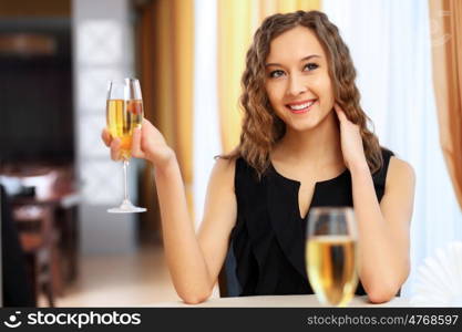 Portrait of a young pretty woman sitting in restaurant