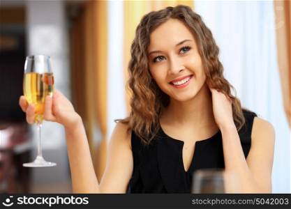 Portrait of a young pretty woman sitting in restaurant