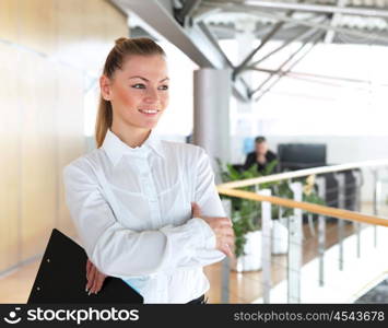 portrait of a young pretty woman standing inside office building