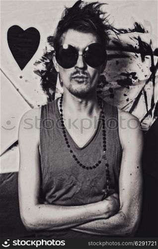 Portrait of a young punk in the round sunglasses closeup